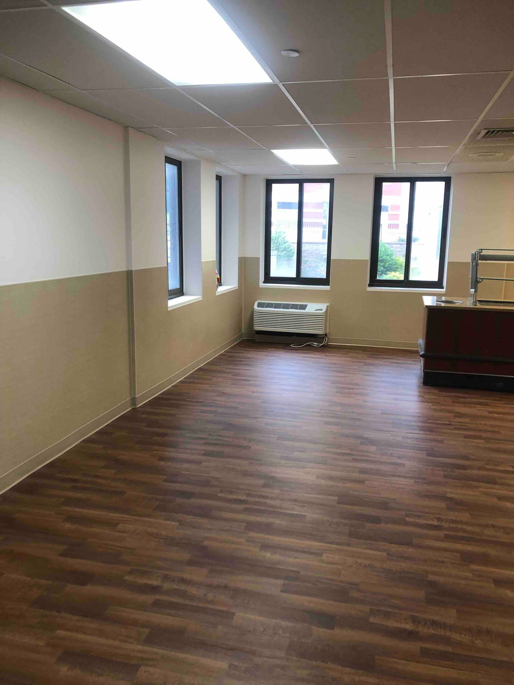Photo showing finished common room floor, walls and windows