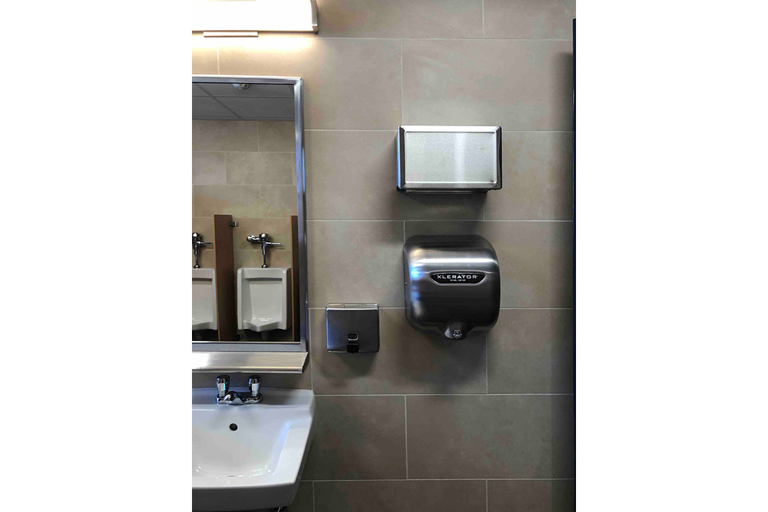 photo showing tiled wall detail and hand dryer